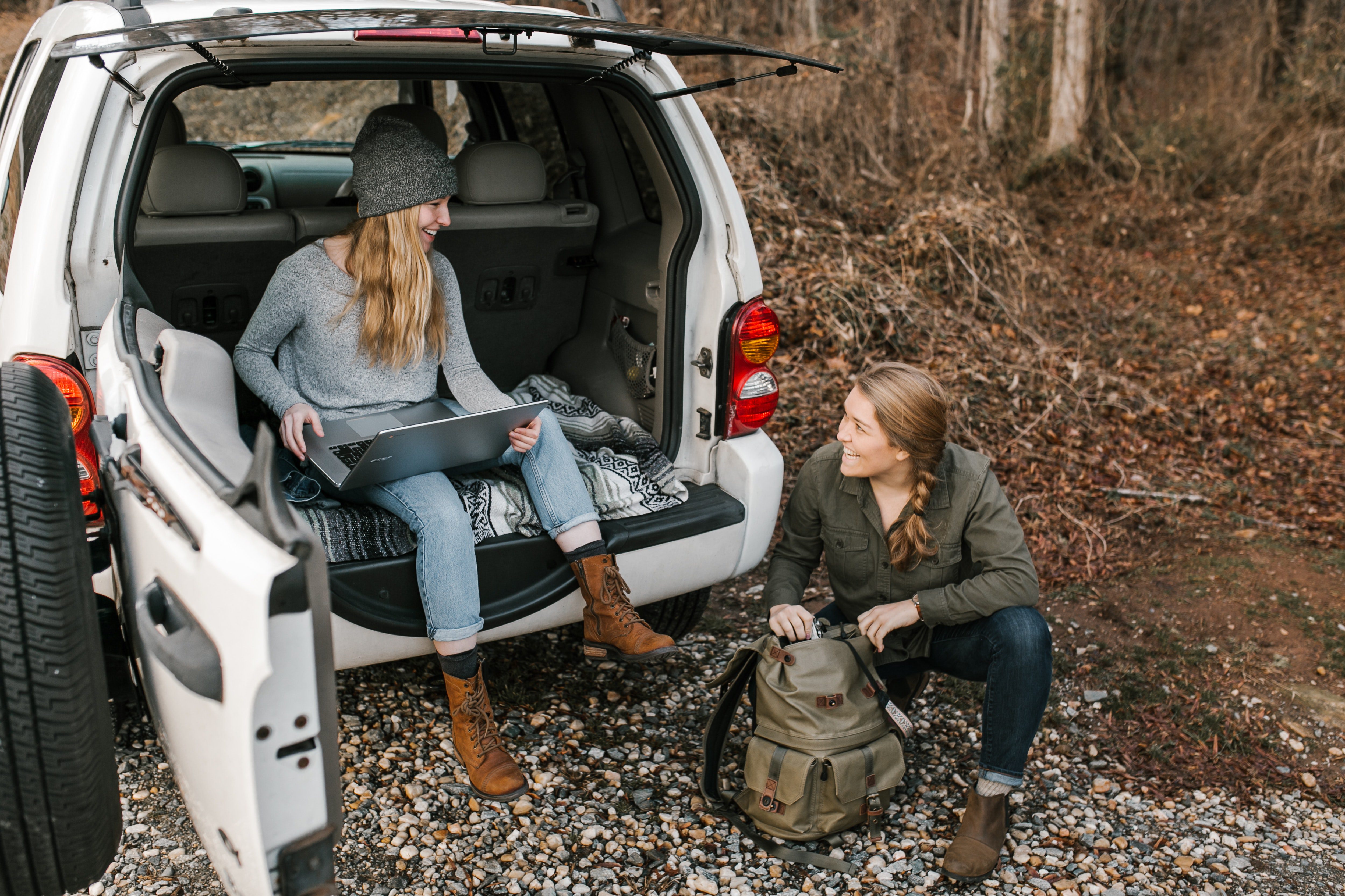 2 women working remotely in their car