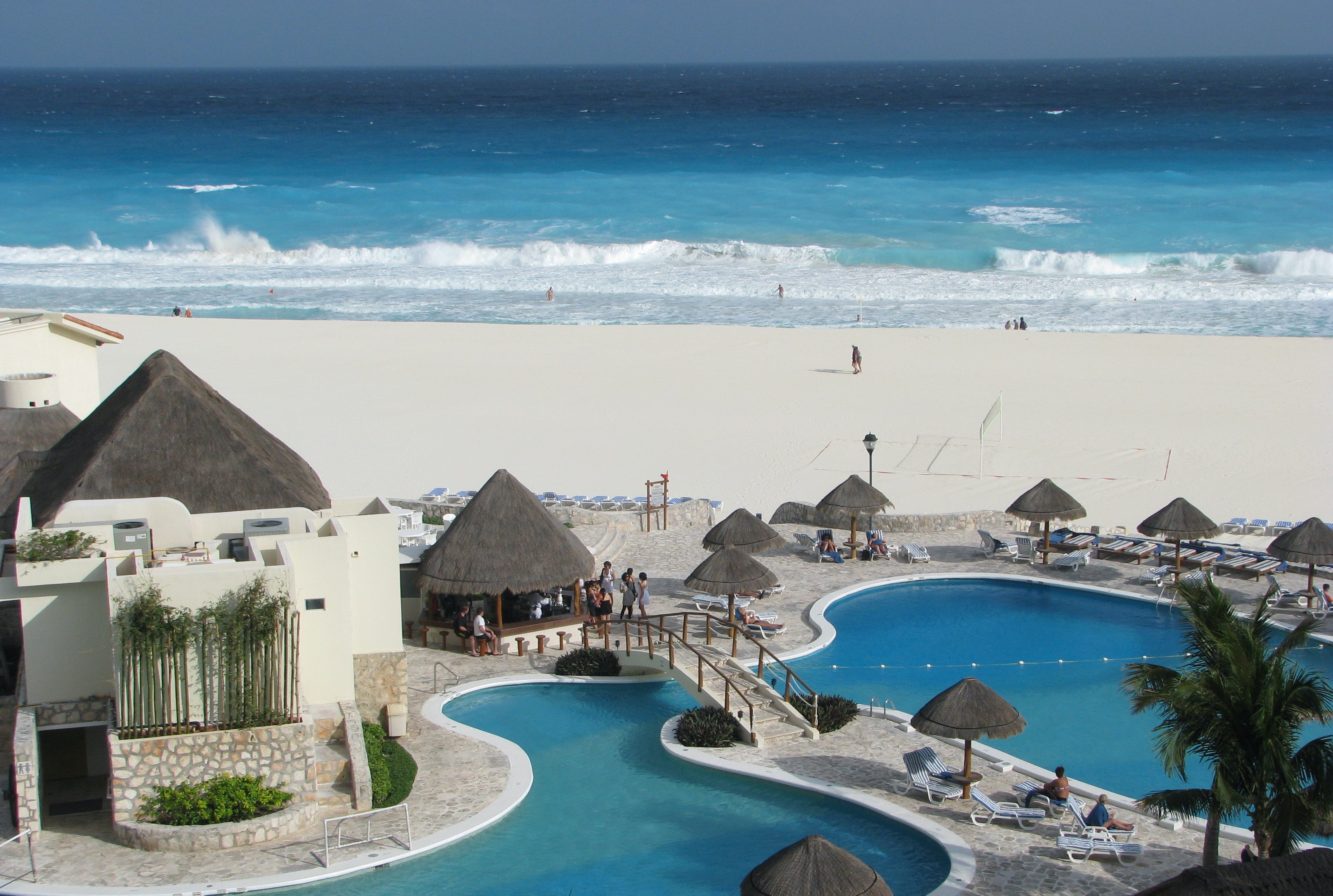 grey gazebos besides swimming pool