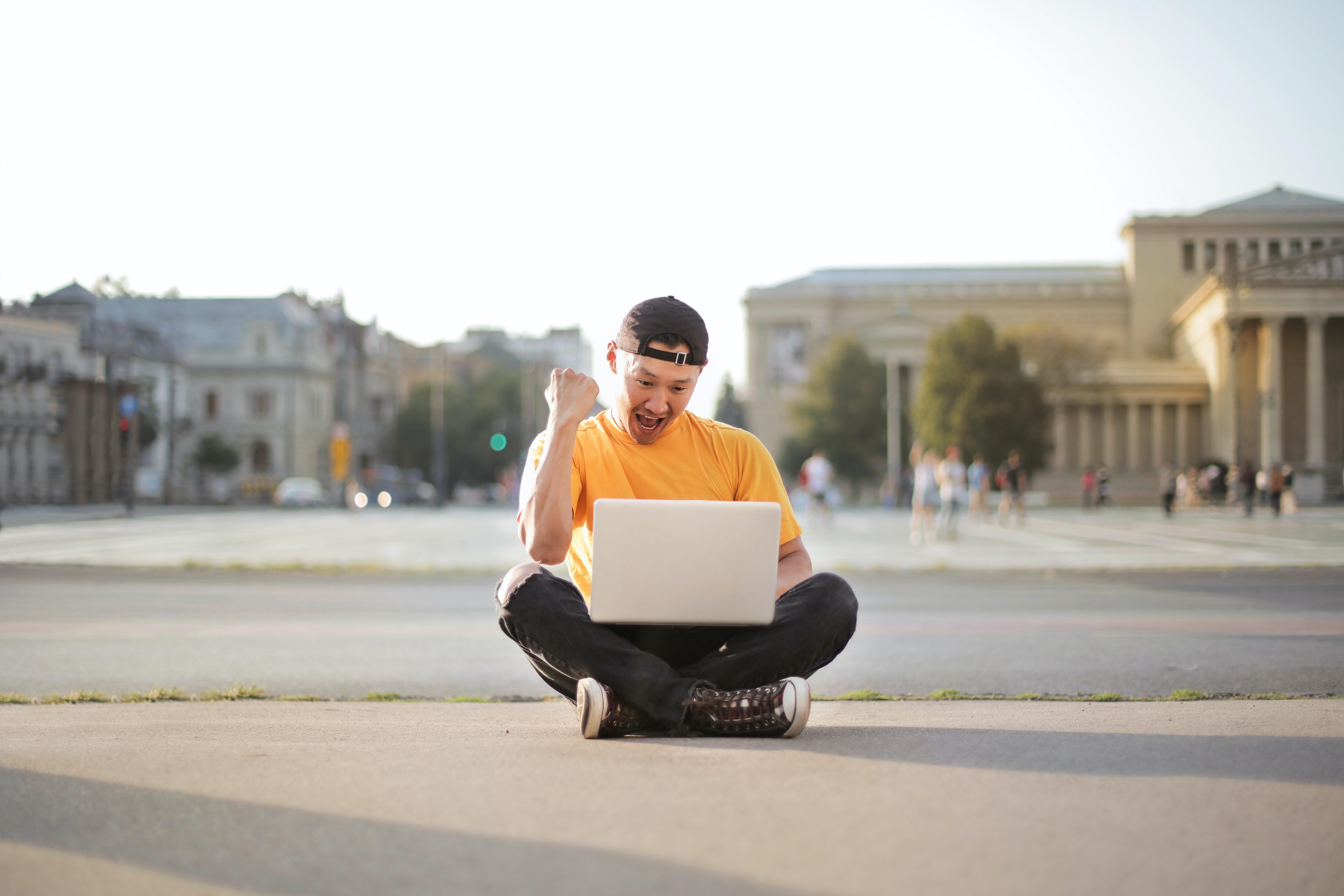 man showing an excited face while working on his laptop